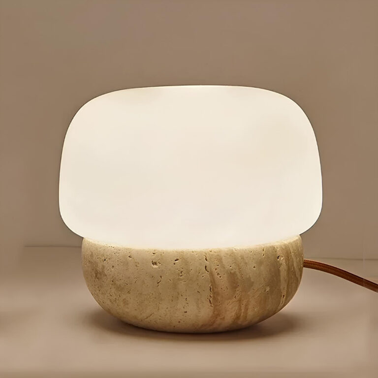 Lampe champignon avec pied en travertin. Allumée et relié par un câble à droite. Sur fond marron clair.